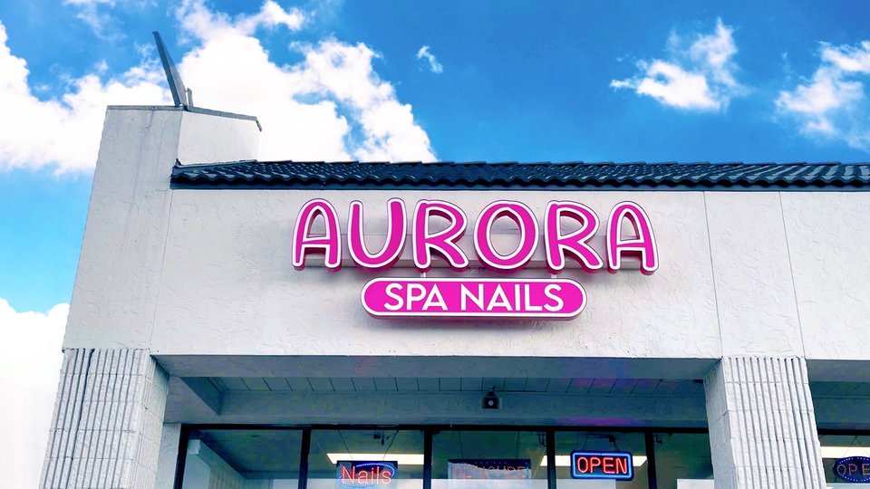 Nail salon displays colorful manicure designs.